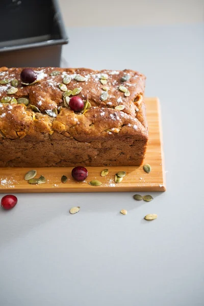 Closeup on freshly baked pumpkin bread with seeds on table — Stock Photo, Image