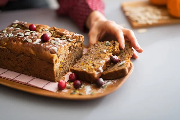 Young housewife taking piece of freshly baked pumpkin bread — Stock Photo, Image