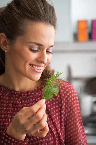Portrait of young housewife holding fresh dill — Stock Photo, Image