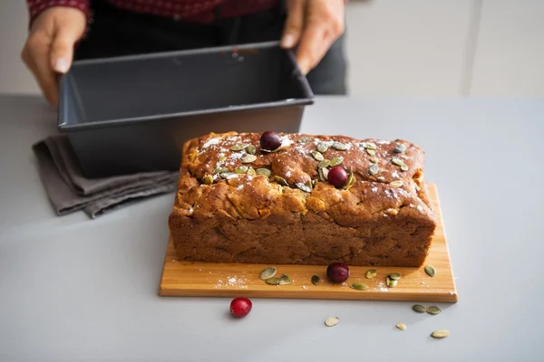 Closeup on young housewife showing freshly baked pumpkin bread w Stock Photo