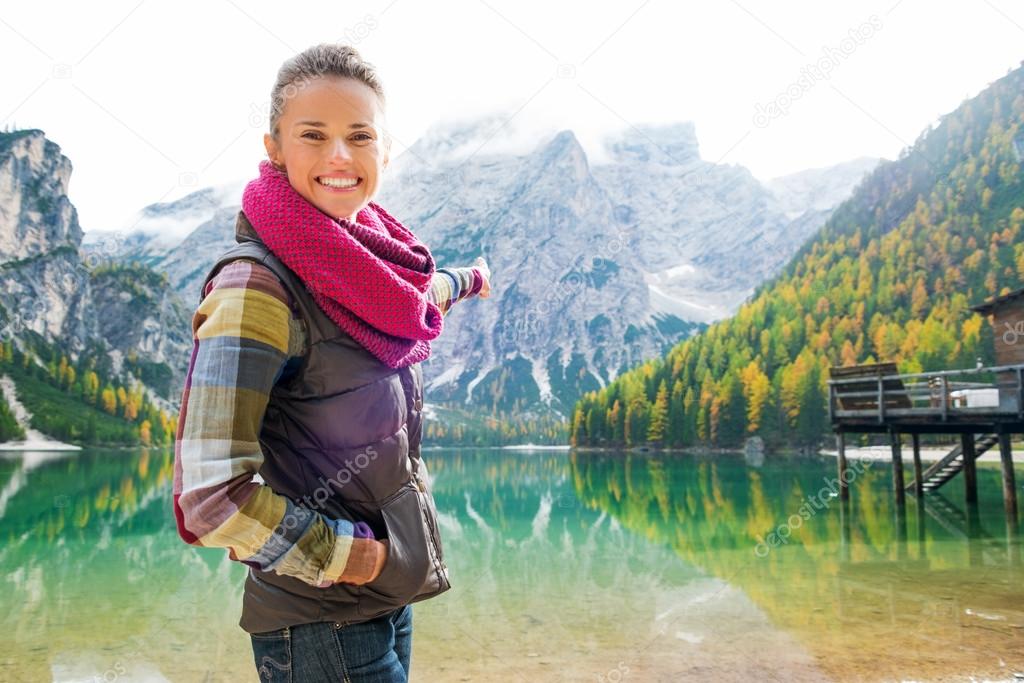 Smiling woman hiker at Lake Bries pointing at scenery