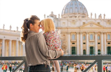 Eskimo kisses between mother and child at the Vatican in Rome clipart