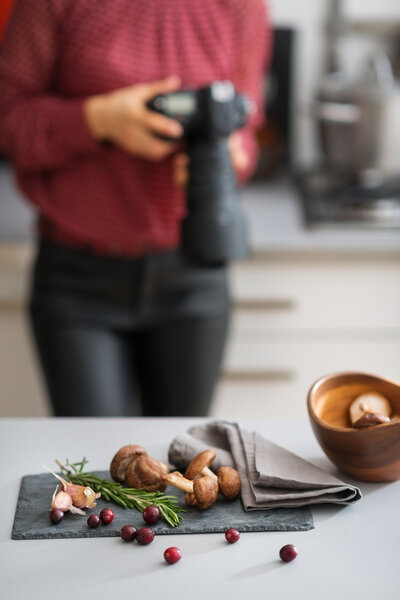 Woman photographer with autumn fruits and vegetables