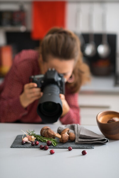 Woman photographer taking photos of autumn fruits and vegetables