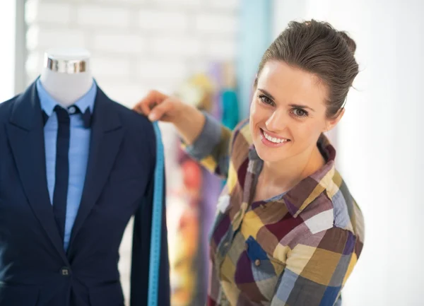 Tailor woman measuring business suit — Stock Photo, Image