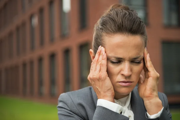 Portrait of stressed business woman in front of office building — Stok fotoğraf