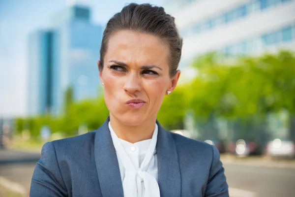 Portrait of thoughtful business woman in office district — Stock Photo, Image