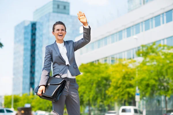 Happy business woman with briefcase in office district greeting — 图库照片