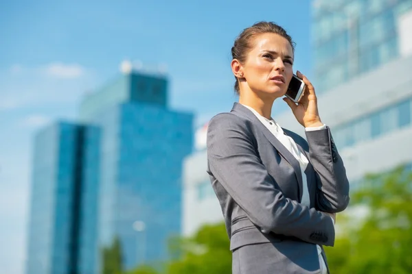 Portrait of happy business woman talking cell phone in office di — Stock Photo, Image