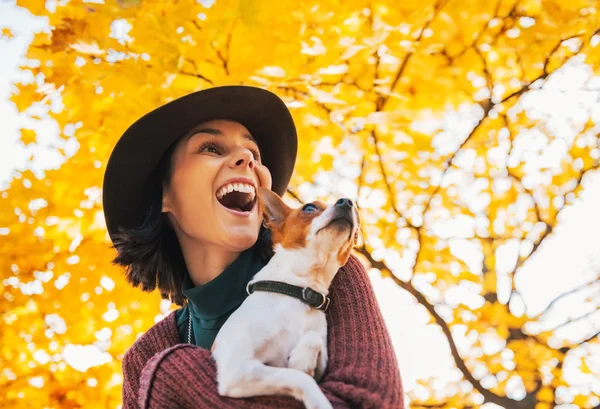 Retrato de jovem mulher feliz com cão ao ar livre no outono lookin — Fotografia de Stock