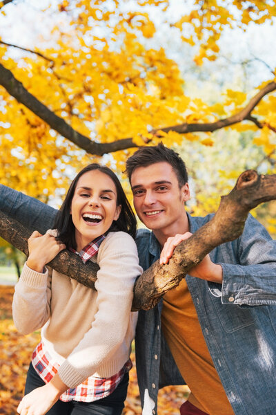 Portrait of smiling young couple outdoors in autumn