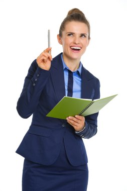 Businesswoman holding open notebook and pen having aha moment clipart