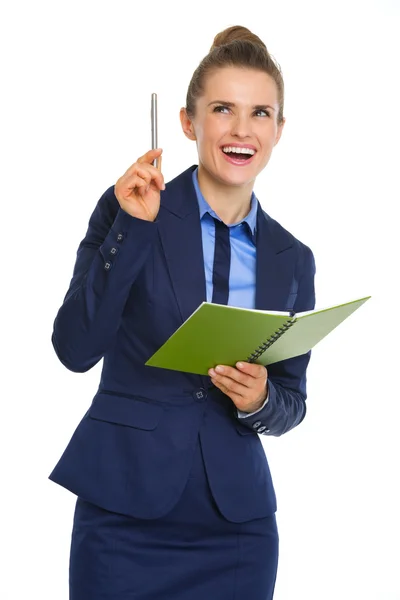 Empresária segurando caderno aberto e caneta tendo um momento aha — Fotografia de Stock