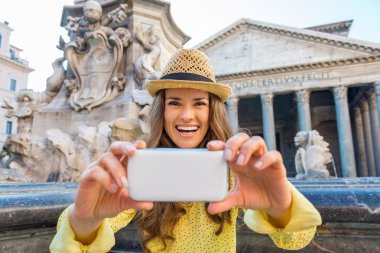 Happy woman looking up from taking photos at Pantheon
