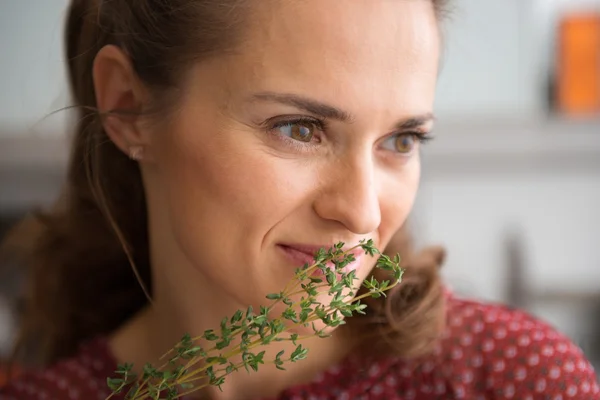 Closeup of woman smelling fresh thyme — Stockfoto