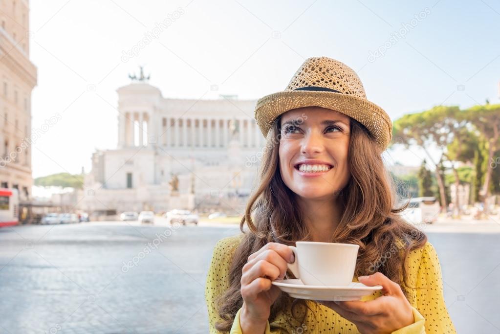 Smiling woman enjoying a cup of coffee near Venice Square