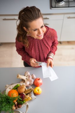 Seen from above, woman smiling with fall fruits and vegetables