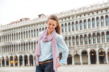 Smiling woman tourist on St. Mark's Square