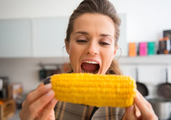 Closeup of woman opening mouth wide to take bite of corncob — 스톡 사진