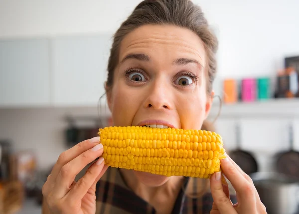 Teasing, happy woman taking big bite of corn on the cob — 스톡 사진