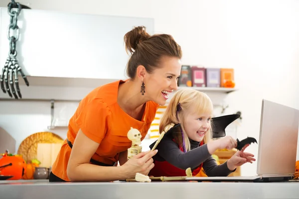 Happy mother with halloween dressed daughter having video chat — Stock Photo, Image