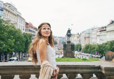 Happy bohemian woman tourist sightseeing in Prague