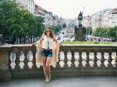 Hippy-looking woman tourist standing on Wenceslas Square, Prague