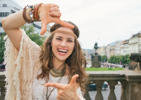 Happy bohemian woman tourist framing with hands in Prague — Stockfoto