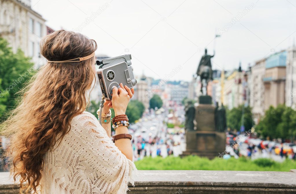 Trendy hippie woman tourist with vintage retro camera  in Prague