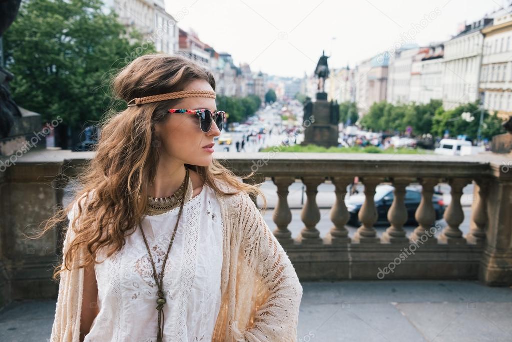Trendy hippie woman tourist standing on Wenceslas Square, Prague