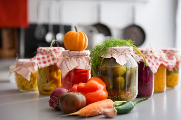 Closeup of preserved vegetables in glass jars — Stock Photo, Image