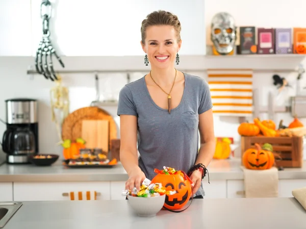 Woman preparing trick or treat candy for Halloween party — 스톡 사진