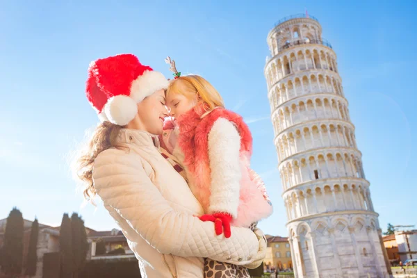 Happy mother with daughter spending Christmas in Pisa, Italy