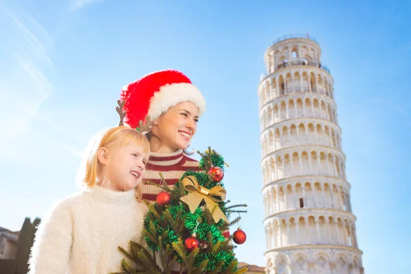 Woman and baby girl holding Christmas tree. Pisa, Italy — Φωτογραφία Αρχείου