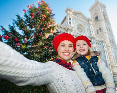 Mother and daughter taking selfie near Christmas tree, Florence