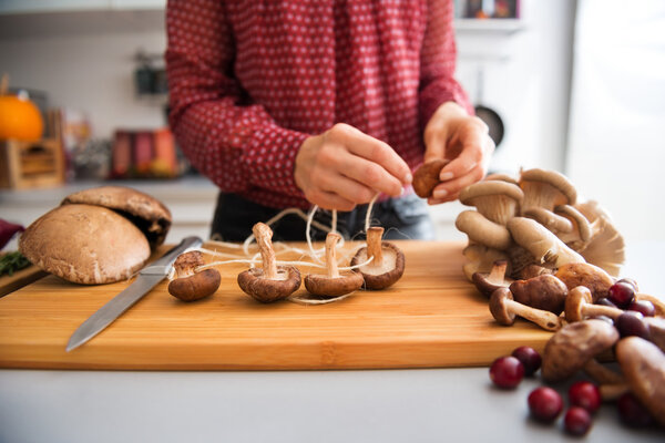 Closeup of mushrooms being strung together