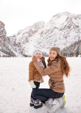 Portrait of mother and child spending time in winter outdoors