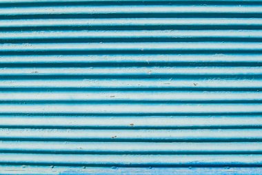 Eski yıpranmış paslı grunge kıvrımlı mavi boyanmış metal levha