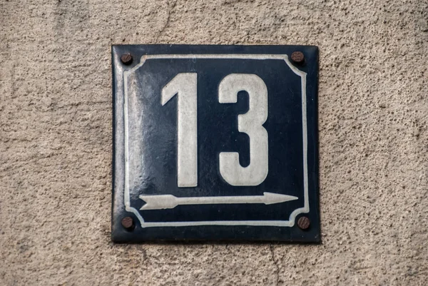 Weathered grunge square metal enamelled plate of number of street address with number 13