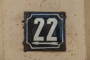 Weathered grunge square metal enamelled plate of number of street address with number 22 clipart