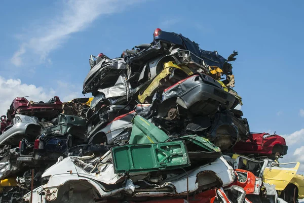 Pile of crushed junk cars on scrapyard