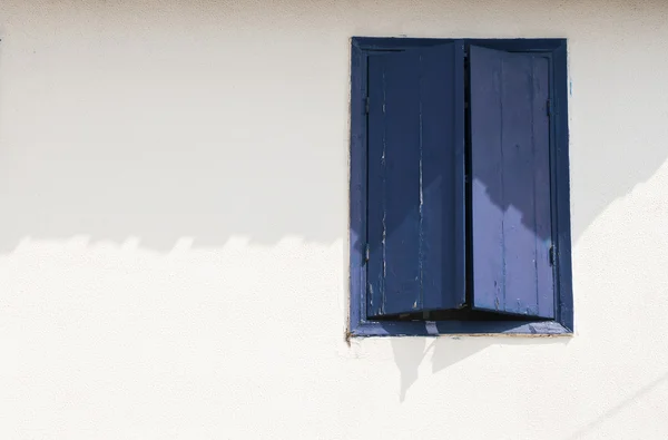 Modré okno na bílé stěně — Stock fotografie