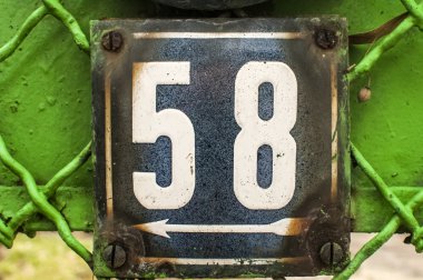 Weathered enameled plate number 58