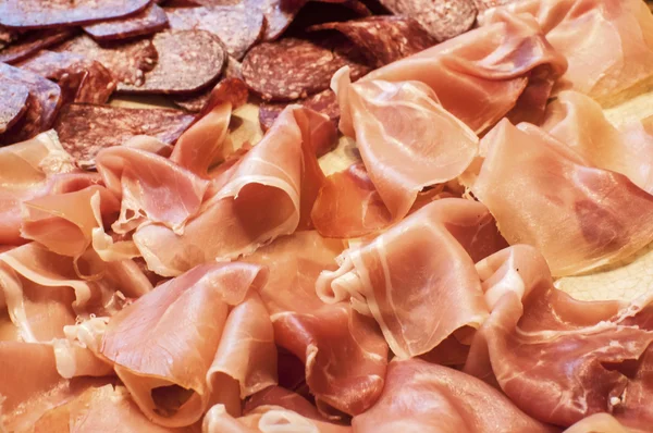 Sliced dry sausages and prosciutto — Stock Photo, Image