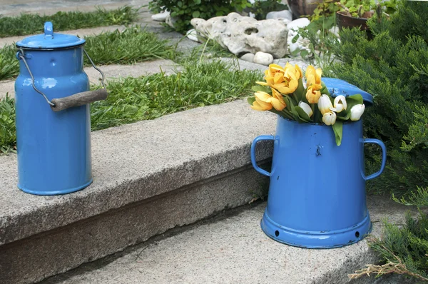 Blue enamel jugs on stone steps