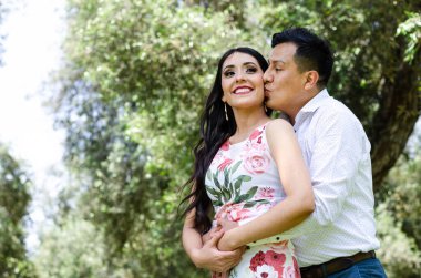 Mutlu genç çift dışarıda sarılıp gülüyor..