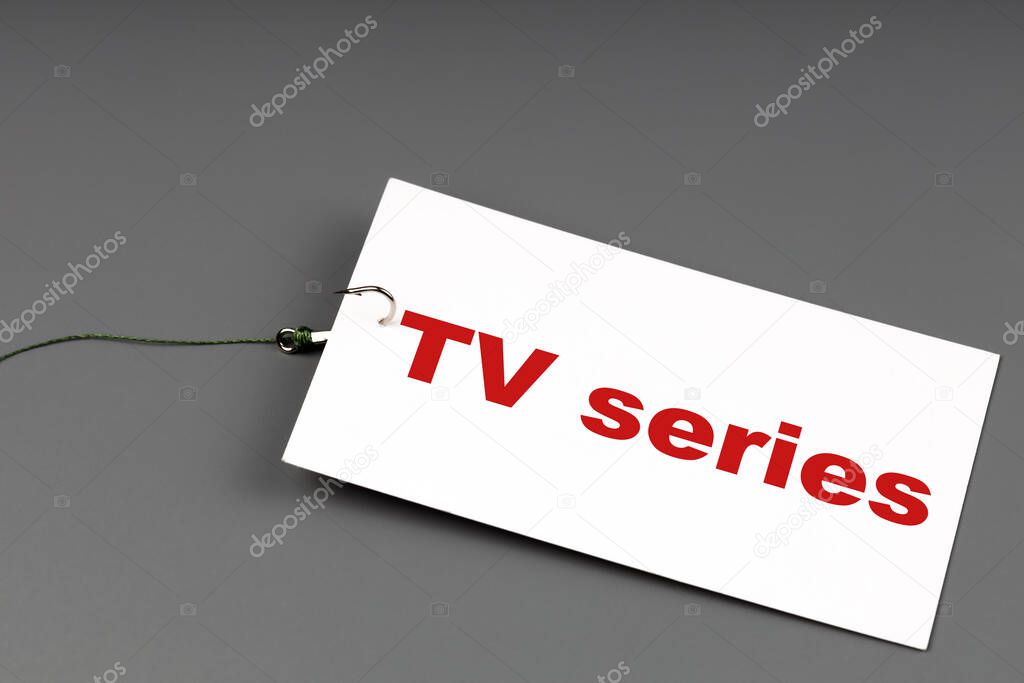 white card with the inscription serials put on a hook. TV series addiction