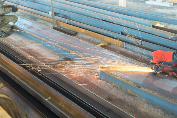 cutting metal with a hand tool in red protective gloves. work without automatic metal cutting