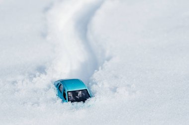 footprints and a car in the snow, a car stuck in a large pile of snow. snowfall on the road clipart