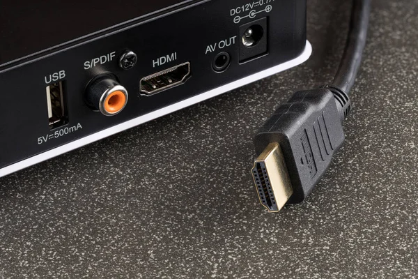 a close-up of an hdmi cable for a TV set-top box is pulled out of it. disabled device